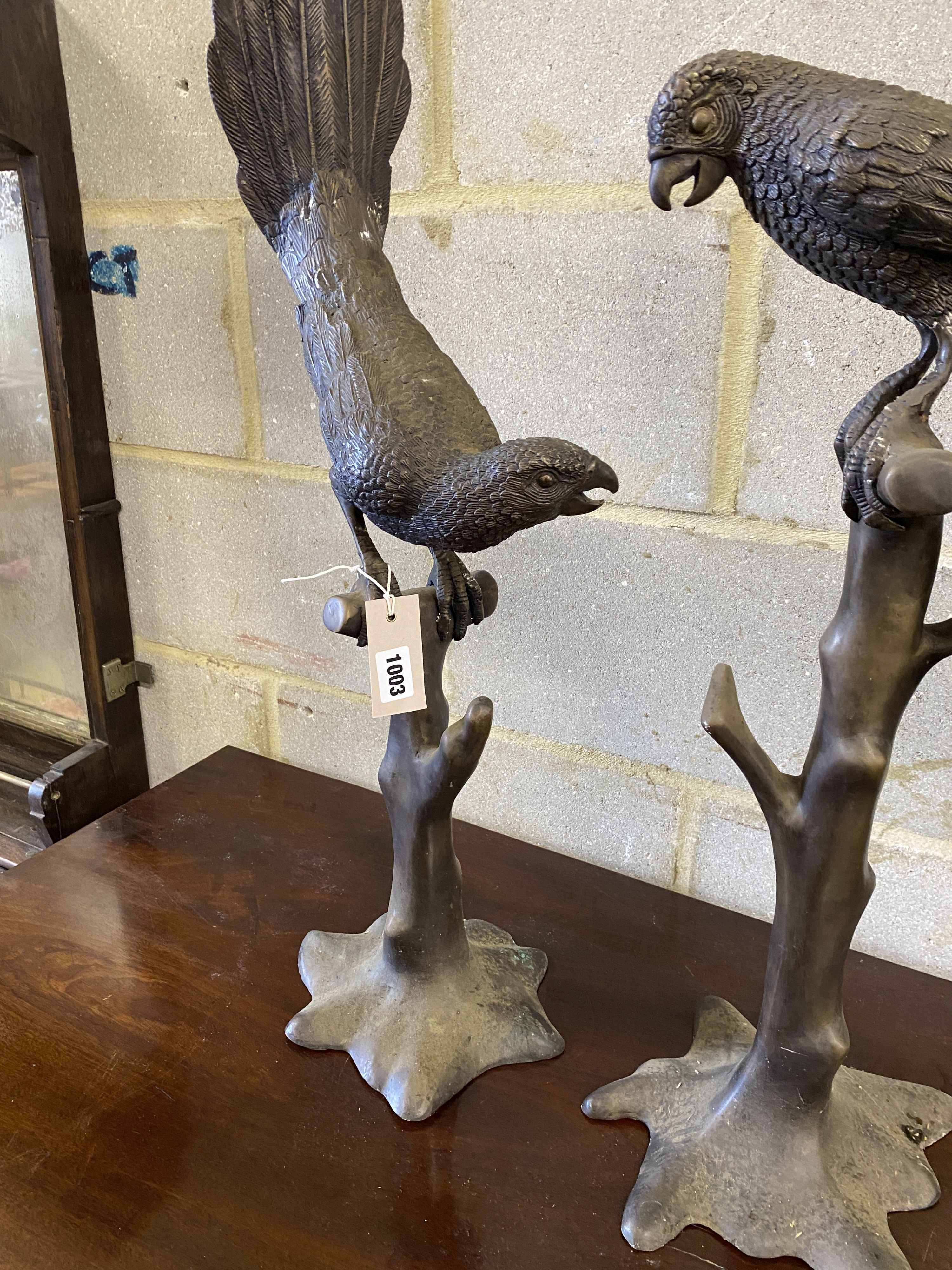 A pair of patinated cast metal macaws, larger height 88cm